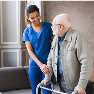 A female caregiver assisting a senior man