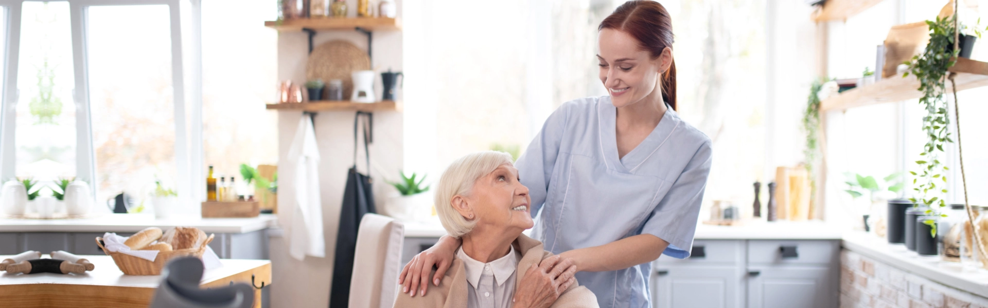 A female caregiver and a senior woman sitting