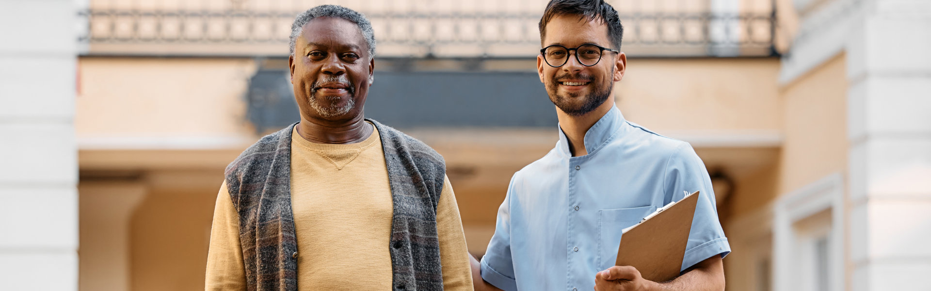 A male and a senior man smiling