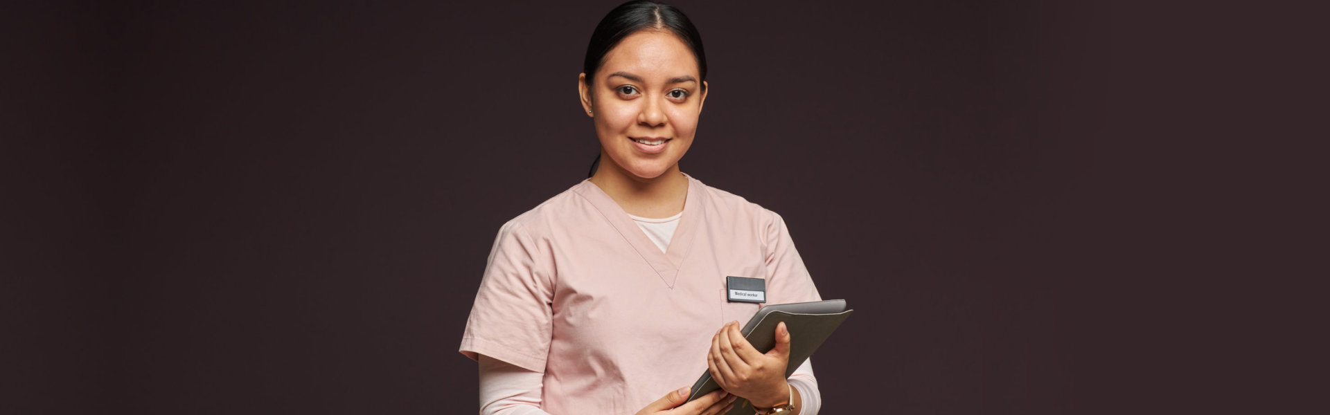 A female caregiver smiling