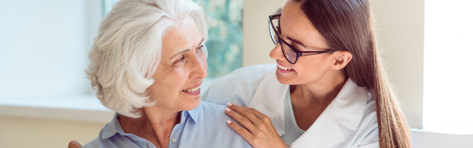 A senior woman and a female looking at each other